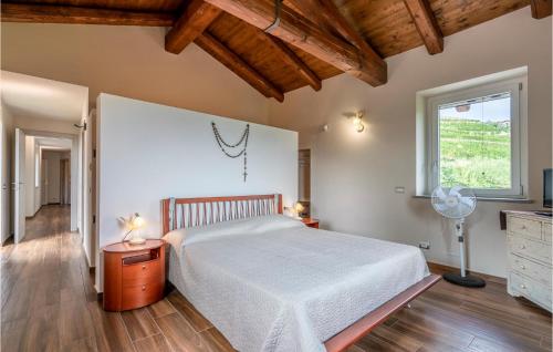 a bedroom with a large bed and a window at Stunning Home In Castino With Wifi And 4 Bedrooms in Castino