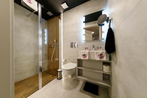 a bathroom with a shower and a toilet and a sink at Kamienica no 111a in Warsaw