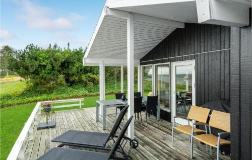 a patio with a table and chairs on a deck at Beautiful Home In Faaborg With Kitchen in Fåborg