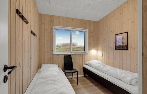 a room with two beds and a window at Beautiful Home In Spttrup With Wifi in Lihme