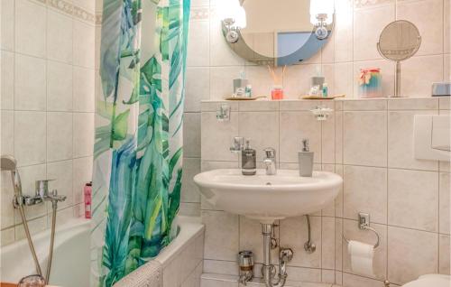 a bathroom with a sink and a shower curtain at Lovely Apartment In Schleswig With Wifi in Schleswig