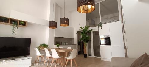 a kitchen and dining room with a table and chairs at SABOTINO APARTMENT in Civitanova Marche
