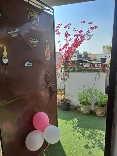 a refrigerator with a bunch of balloons on the door at Private room with Sky Garden in Green Bacchus by Walias in Gurgaon