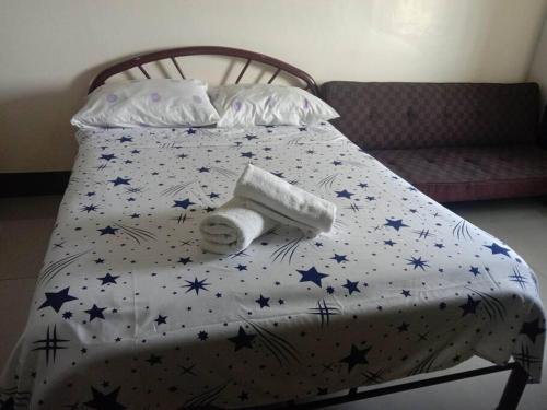 a bed with a comforter with stars on it at Unit Near SM City,Gaisano Mall of Cebu,Robinsons Galleria in Cebu City