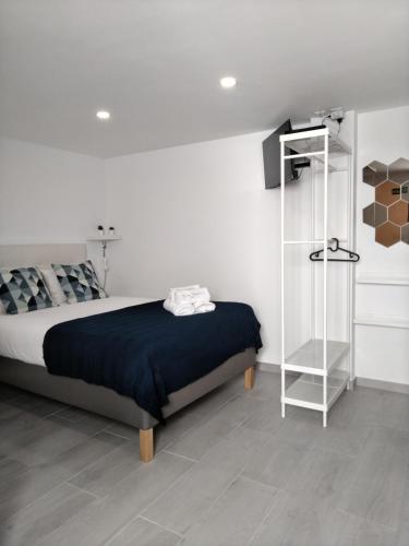 a bedroom with a bed and a book shelf at Tomarhousing - Garden in Tomar