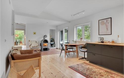 a kitchen and living room with a table and a couch at 3 Bedroom Stunning Home In Nykøbing Sj in Holmstrup