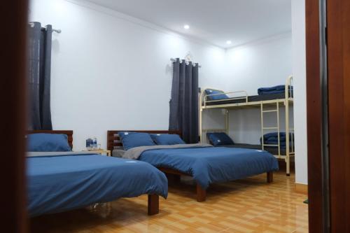 Ένα ή περισσότερα κρεβάτια σε δωμάτιο στο Big Măng Đen Homestay