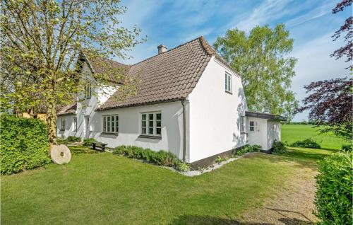 a white house with a yard at Cozy Home In Rudkøbing With Wifi in Rudkøbing