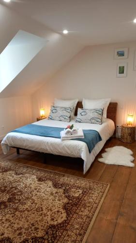 a bedroom with a bed with blue sheets and pillows at LA LANDE in Pleyber-Christ