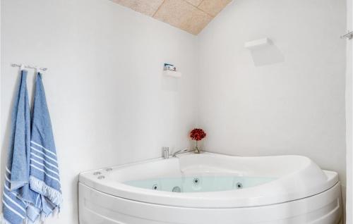 a bath tub in a bathroom with a blue towel at Cozy Home In Vestervig With Wifi in Vestervig