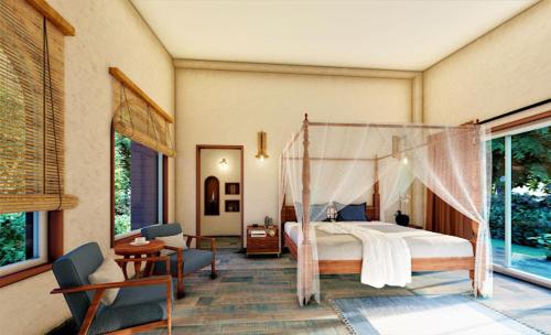 ein Schlafzimmer mit einem Himmelbett in der Unterkunft Bhil's Kabeela Resort & Spa Kanha in Dhanwār