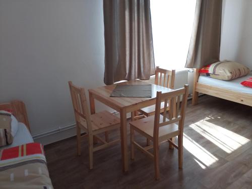 a room with a table and chairs and a bed at Penzion Athéna - sportovní areál in Nová Včelnice