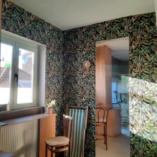 a living room with a wall covered in wallpaper at Atelier Aan Zee in Ostend