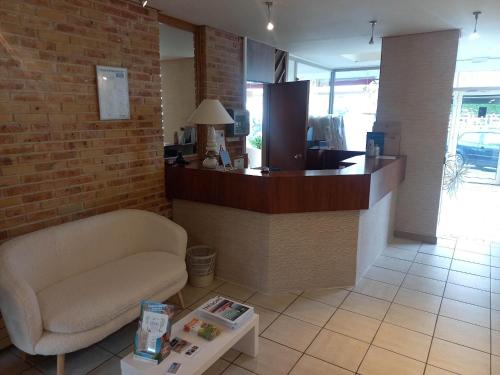 a lobby with a bar with a chair and a table at Hotel De La Mer in Saint Malo