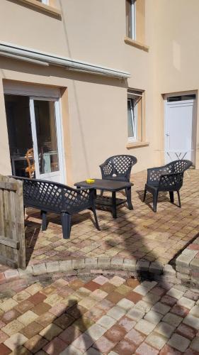 three benches and a table on a patio at Les Hauts de Sochaux in Sochaux