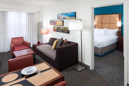 a hotel room with a couch and a bed at Residence Inn South Bend Mishawaka in South Bend