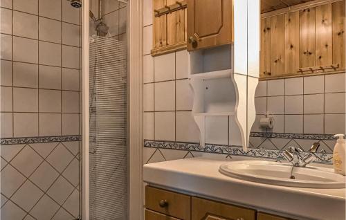 a bathroom with a sink and a shower at Nice Home In Straumgjerde With Kitchen in Brunstad