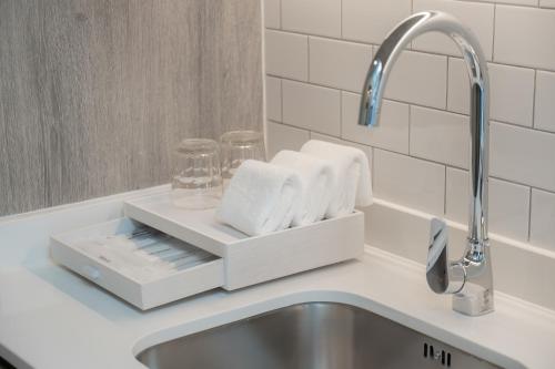 a bathroom sink with a tray with towels on it at Staybridge Suites Bangkok Sukhumvit by IHG in Bangkok