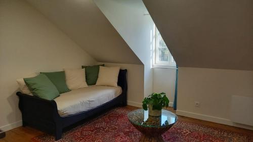 a living room with a couch and a table at LA LANDE in Pleyber-Christ