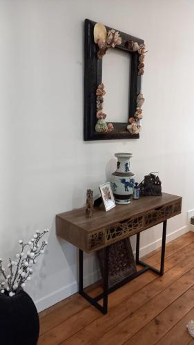 a table with a mirror on a wall at LA LANDE in Pleyber-Christ