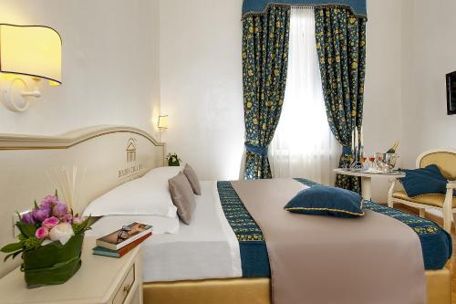 a hotel room with a bed and a window at Dimora Degli Dei in Rome