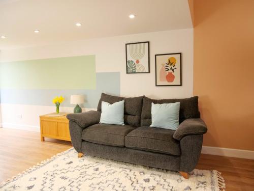 a living room with a couch and a table at Ellingham Self-Catering Cottages in St Peter Port