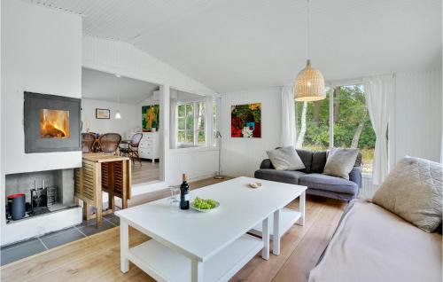 a living room with a white table and a couch at Beautiful Home In Melby With Kitchen in Melby