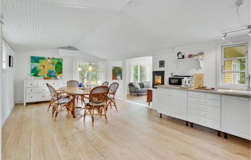a kitchen and dining room with a table and chairs at Beautiful Home In Melby With Kitchen in Melby