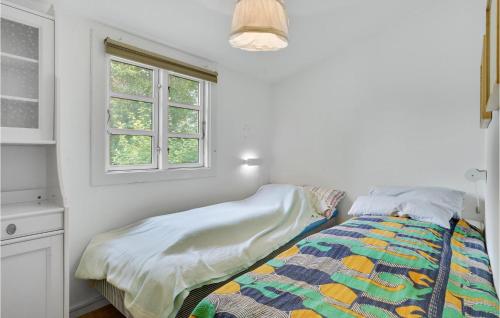 a bed in a white room with a window at Beautiful Home In Melby With Kitchen in Melby