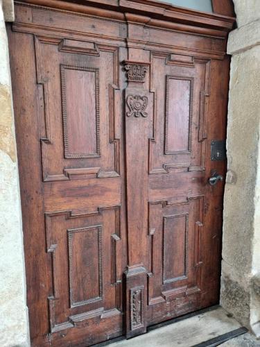 an old wooden door in a building at Stylový byt v srdci Hradce Králové in Hradec Králové
