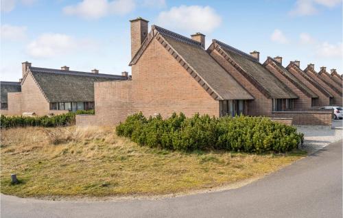 a brick house with a row of roofs at 2 Bedroom Cozy Home In Rømø in Sønderby