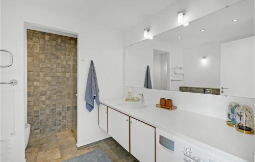 a white bathroom with a sink and a mirror at 2 Bedroom Cozy Home In Rm in Sønderby
