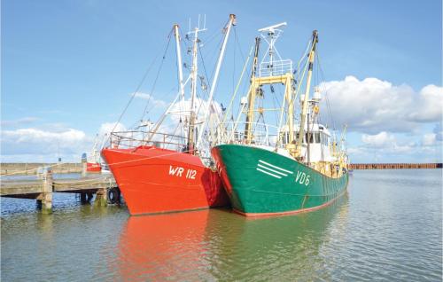 two boats are docked at a dock in the water at 2 Bedroom Cozy Home In Rømø in Sønderby