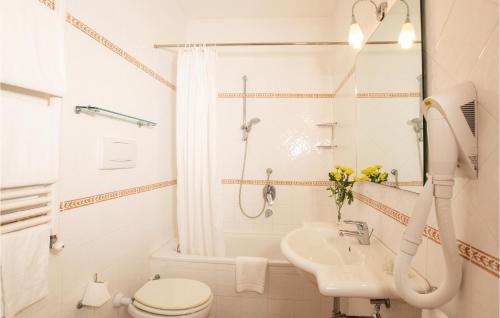 a white bathroom with a toilet and a sink at Apt B5 in Grosseto