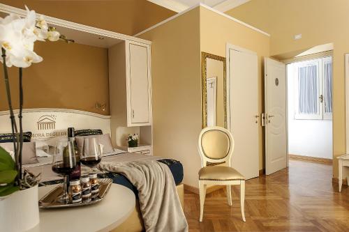 a bedroom with a bed with a table and a chair at Dimora Degli Dei in Rome