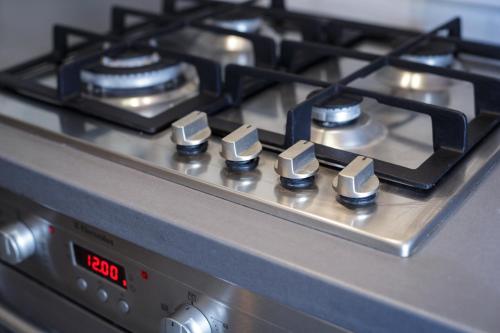 a close up of a gas stove top at ParkCosyLux Free parking in Rīga