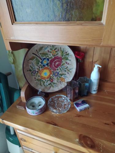 a wooden shelf with a plate and other items on it at Da Santina in Pieve Santo Stefano