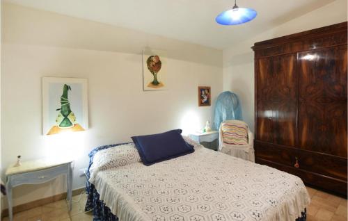 a bedroom with a bed and a wooden cabinet at Amazing Home In Modica With Sauna in Modica