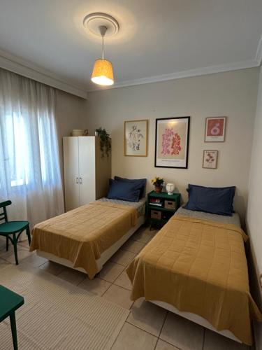 a bedroom with two beds and a table at The ART space in Kavala in Kavála