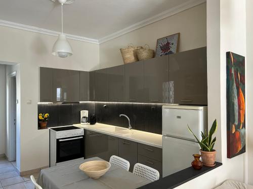 a kitchen with black and white cabinets and a sink at The ART space in Kavala in Kavála