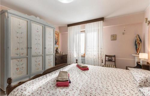 a bedroom with a bed with two bags on it at App Heli in San Zeno di Montagna