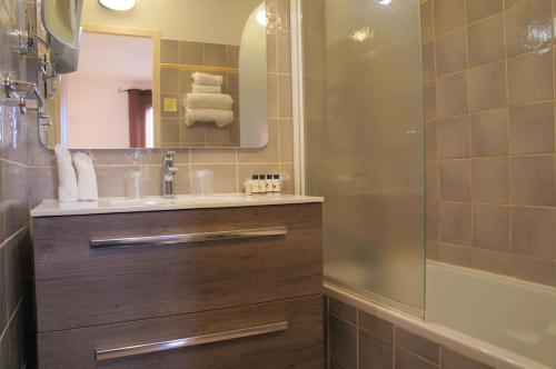 a bathroom with a sink and a shower at Hotel Terriciaë Maussane in Maussane-les-Alpilles