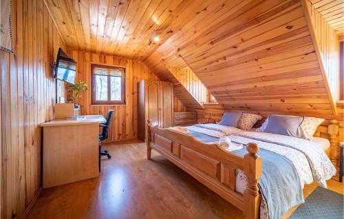 a log cabin bedroom with a bed and a desk at Lake Front Home In Donja Stubica With House A Mountain View in Donja Stubica
