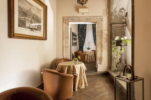 a dining room with a table and chairs in a room at Dimora Degli Dei in Rome