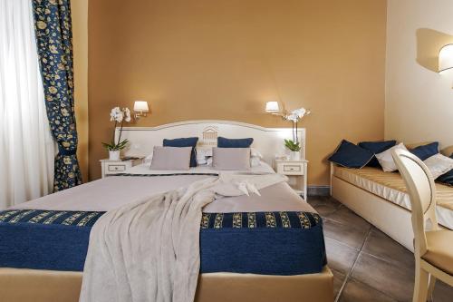 a bedroom with a large bed with blue pillows at Dimora Degli Dei in Rome