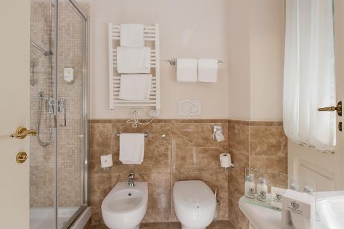 a bathroom with a toilet and a sink and a shower at Dimora Degli Dei in Rome