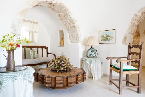 a living room with a table and chairs at I Trulli di Paolo in Martina Franca