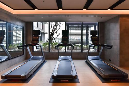 a gym with two treadmills in a room at Four Points by Sheraton Taipei Bali in Bali