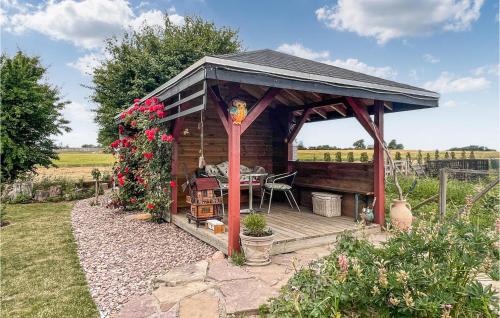 a wooden gazebo with a table in a garden at Nice Apartment In Østermarie With Wifi in Østermarie
