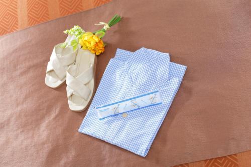 a table topped with blue and white napkins and flowers at HOTEL MYSTAYS Maihama in Urayasu